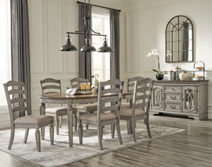 This dining room group adds understated beauty to any dining space with its traditional cottage design. Its outstanding two-tone finish features an antiqued gray body with a rich deep walnut brown top. This ample round table includes one extension leaf to