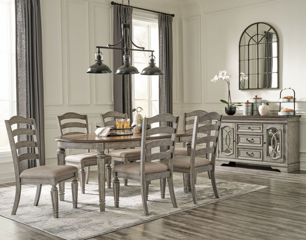 This dining room group adds understated beauty to any dining space with its traditional cottage design. Its outstanding two-tone finish features an antiqued gray body with a rich deep walnut brown top. This ample round table includes one extension leaf to