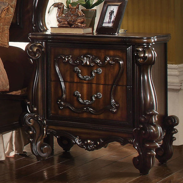 The Versailles nightstand is the perfect accent to create the style of royalty your bedroom has been needing. This nightstand crafted in wood with cherry oak finish was inspired by old European design with brown copper metal hardware and intricate wood ca
