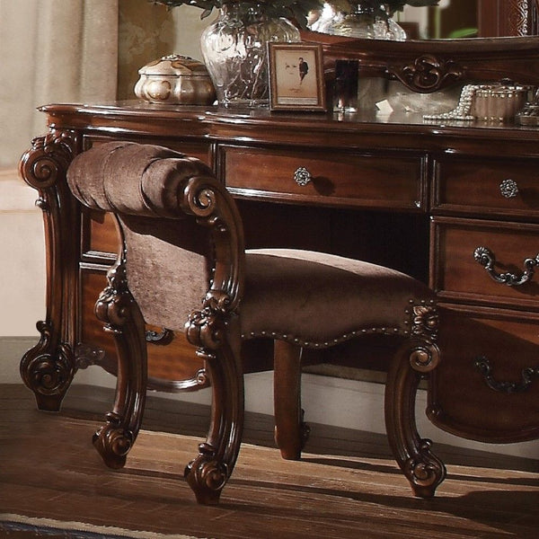 Create an elegant, traditional design in your bedroom with the cherry Vendome vanity stool. This hand-crafted piece inspired from the luxurious designs of the past, this stool features elaborate wood carving details, traditional hardware and a sophisticat