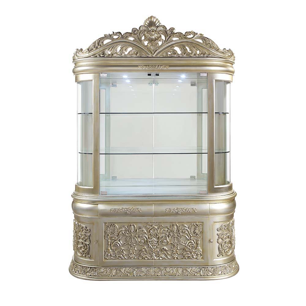 Create an eye-catching functional focal point of opulence with the Sorina curio cabinet that is grand, yet charming and approachable. Finished in gold and silver, the cabinet glistens with a touch of glam, featuring a mirrored back panel and a top crown. 