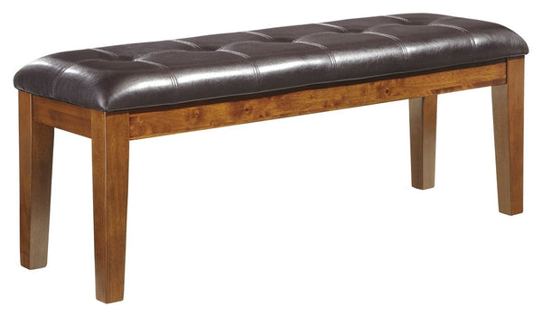 This large upholstered dining room bench beautifully captures the essence of rustic refinement. Plushly upholstered faux leather makes pulling up a seat so much more enticing. Makes for easy cleanup, too.<br/><br/><b>Product Features</b><ul><li>Made of ve