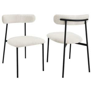 Upgrade your kitchen or dining room seating experience with a set of two modern side chairs. Each boasts a slim framework crafted in durable metal. A black finish creates depth and contrast, offering the perfect complement to soft white boucle upholstery.