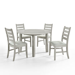 Experience the Pascal 5 Piece Dining Room Set in Driftwood Gray, featuring a round wood table and four dining chairs. Crafted from a blend of solid Rubberwood and manufactured woods, this set ensures long-lasting durability. The solid wood chairs are rein