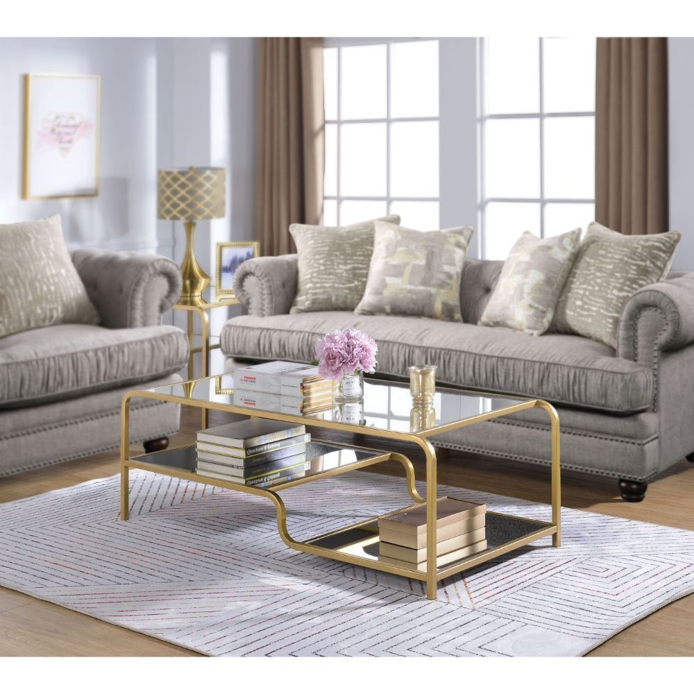 Center your seating arrangement around a sleek and sophisticated style with the Astrid occasional collection. Inspired by timeless materials, it features a mirror top with a stylish curving frame made of refined gold metal coating. An open base and floati