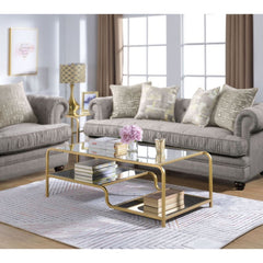 Center your seating arrangement around a sleek and sophisticated style with the Astrid occasional collection. Inspired by timeless materials, it features a mirror top with a stylish curving frame made of refined gold metal coating. An open base and floati