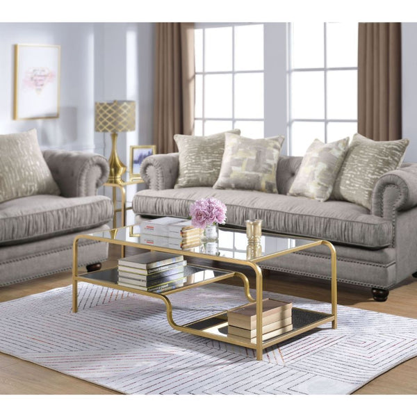 Center your seating arrangement around a sleek and sophisticated style with the Astrid occasional collection. Inspired by timeless materials, it features a mirror top with a stylish curving frame made of refined gold metal coating. An open base and floati