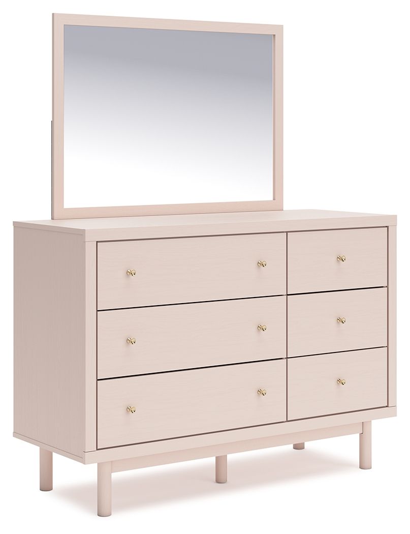 Pretty in pink. This dresser with mirror keeps the spirit of your homeâ€™s modern aesthetic while suiting all your young oneâ€™s needs. Its subtle blush finish brings a playful, charming vibe to organizing clothes and other essentials. Made for her and st
