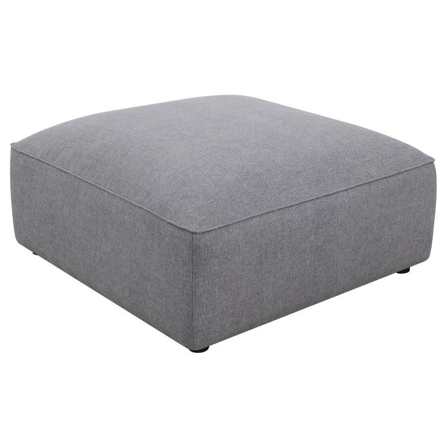 The minimalist design and sophisticated tailored look elevate this contemporary grey ottoman. The large, oversized, boxy shape is upholstered in a soft grey woven fabric that lends it a hint of texture. With a neutral monochromatic color palette, this ott