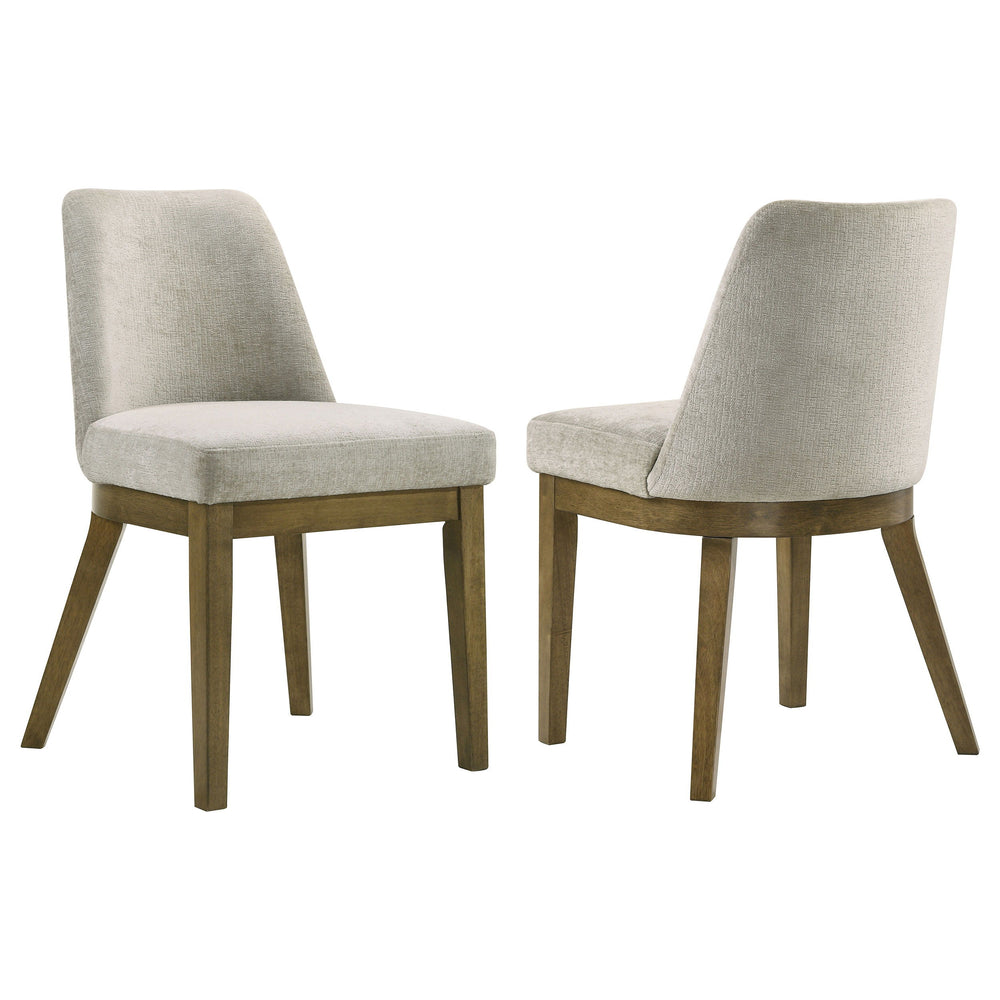 Complete your dining ensemble with this set of two modern side chairs. Offering inviting ambiance to your kitchen or dining room, the pair features a neutral look with a brown oak wood grain finish. Light tan fabric upholstery adds a touch of contrast and