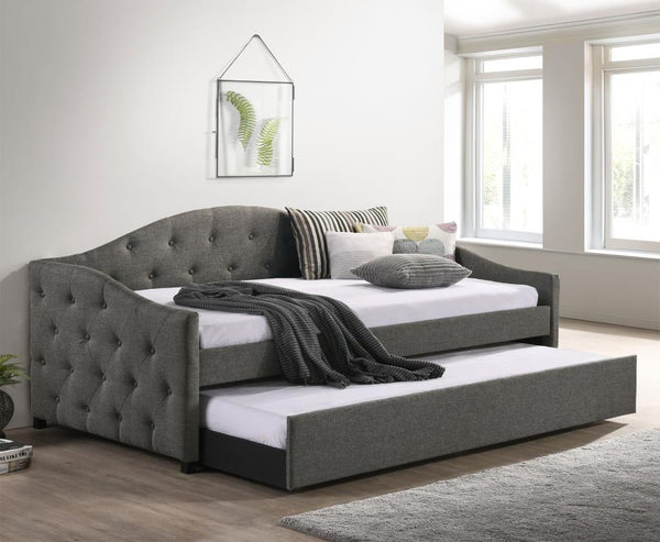  this daybed and trundle combo lends traditional elements such as a button-tufte