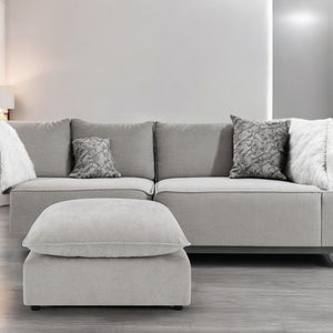 Marisa sectional sofa in luxurious beige boucle fabric is a perfect blend of style and comfort. With its plush pillows and spacious seating, it invites you to unwind in elegance. Ideal for any modern living room, this sectional offers a chic and cozy atmo