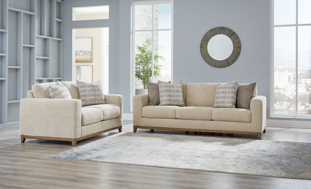 Serene style with a modern sensibility. Delight in the cozy, versatile embrace of this living room set. It takes an on-trend approach to irresistible texture and natural beauty, showcasing soft neutral upholstery accented with a transitional wood trim. As