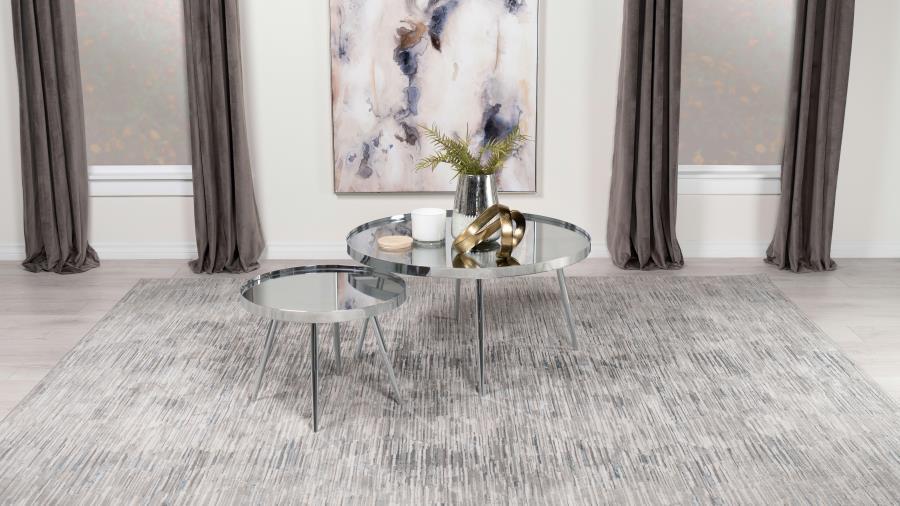 Sleek surfaces and clean lines bring all eyes to a pair of nesting coffee tables that brim with contemporary energy. The tables mirror one another in everything but size, with the smaller table tucking underneath its larger counterpart to conserve space o