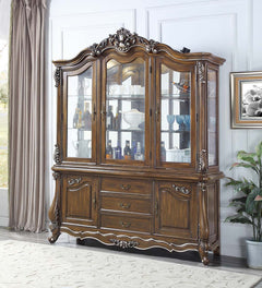 Traditional design with modern accents, the Latisha dining table is the perfect merging of contemporary and classic. The antique oak finish with the hand-brushed silver trim accentuates the elaborate floral moldings that are showcased throughout the legs 
