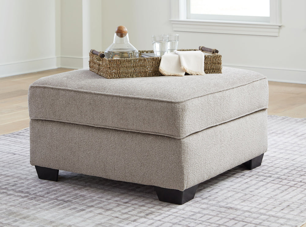 Looking for furniture with extra benefits? This ottoman delivers more than meets the eye, with concealed storage and cup holders beneath the removable cushioned top. With soft upholstery and a generous scale, it greatly enhances your lounge space when pai