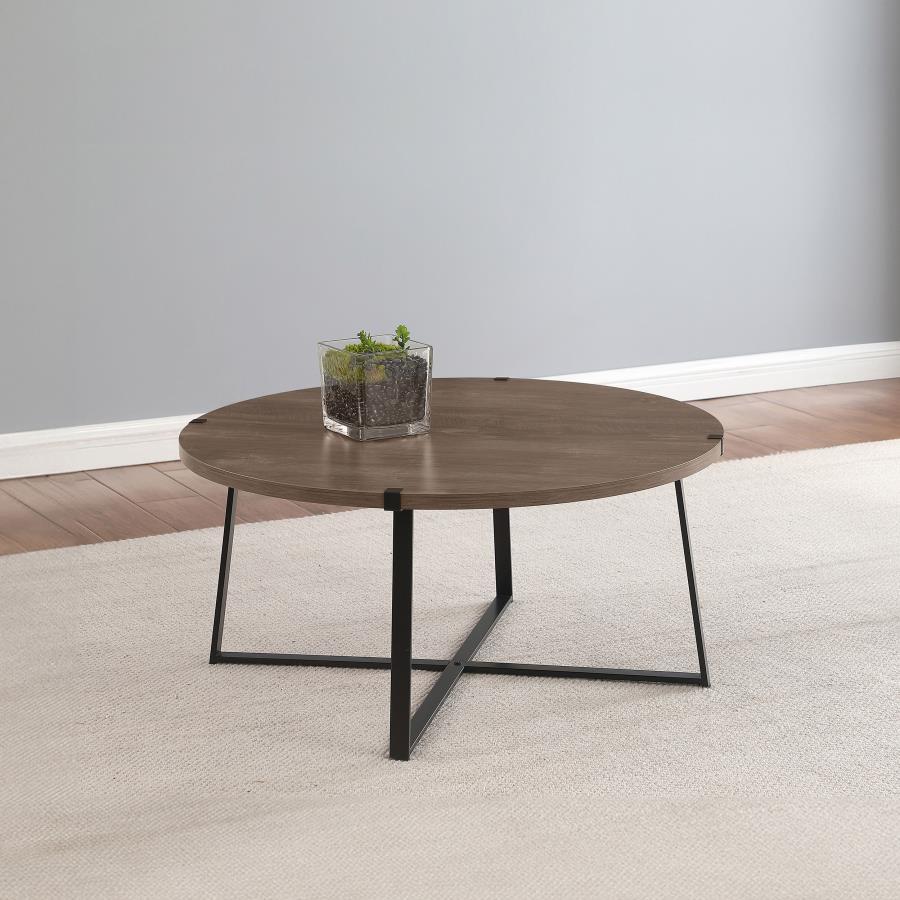 Augment an inviting living space with the stylish look of a modern round coffee table. The table pairs a light brown engineered wood top with a realistic wood grain texture, creating a sense of warmth. The sturdy metal base features a black powder-coated 