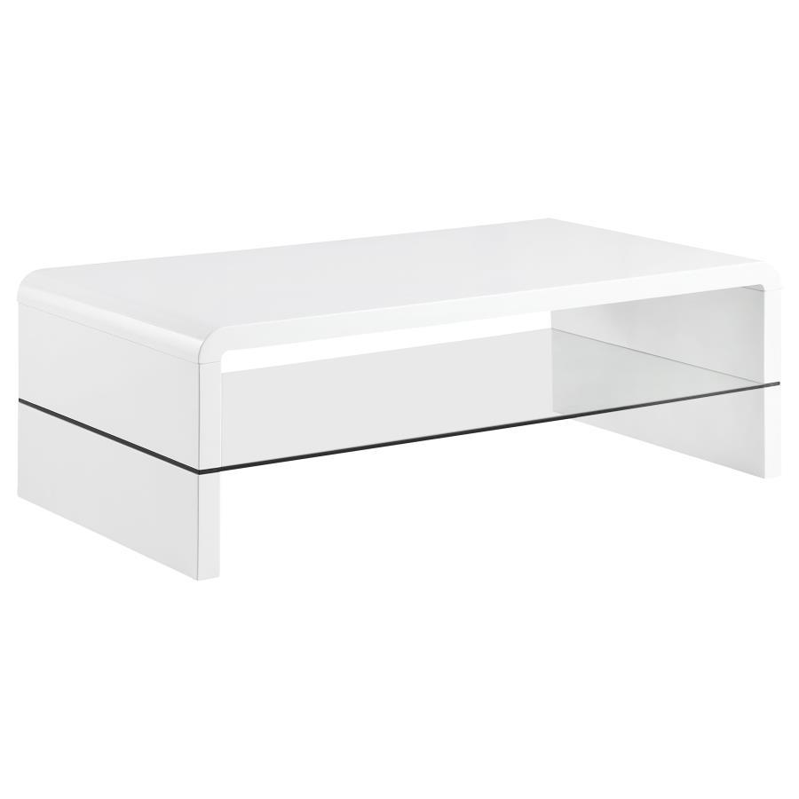 This ultra-modern coffee table showcases a sleek, high-gloss white finish and clean lines. Its rectangular tabletop flows seamlessly into waterfall edges, creating a contemporary silhouette. A clear tempered glass shelf offers an airy, open feel while pro