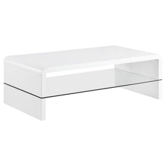 This ultra-modern coffee table showcases a sleek, high-gloss white finish and clean lines. Its rectangular tabletop flows seamlessly into waterfall edges, creating a contemporary silhouette. A clear tempered glass shelf offers an airy, open feel while pro