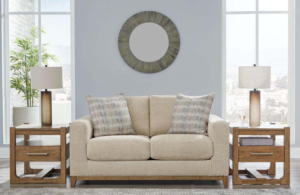 Serene style with a modern sensibility. Delight in the cozy, versatile embrace of this loveseat. It takes an on-trend approach to irresistible texture and natural beauty, showcasing soft upholstery accented with a transitional wood trim. As refined as it 