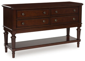 Serve up elegance and poise with this dining server. Its traditional silhouette is detailed with reeded legs for added opulence. Smooth-gliding drawers tuck away linens and other dining accessories when not in use. An open display shelf is the perfect hos