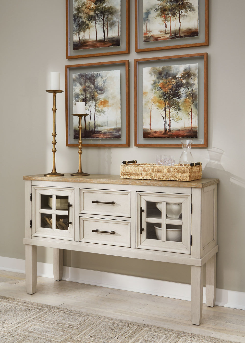 This dining server elevates the art of modern farmhouse design. Its two-tone aesthetic blends antiqued white and light grayish brown for a charming finish. Two windowpane doors with adjustable shelves and dark rustic bar pulls convey a feeling of relaxed 