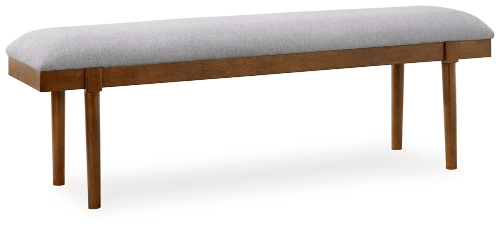 A refreshed take on retro aesthetics. This upholstered bench adds an air of simplicity to your dining space, capturing the architectural language of mid-century stylings. Its seat invites the eye with a soft-edged silhouette and neutral gray cushion. A ca