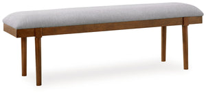 A refreshed take on retro aesthetics. This upholstered bench adds an air of simplicity to your dining space, capturing the architectural language of mid-century stylings. Its seat invites the eye with a soft-edged silhouette and neutral gray cushion. A ca