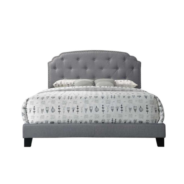  footboard and side rails. It is supported by wood feet and wood headboard posts. The headboard features Nailhead trim bordering an interesting traditional top shape