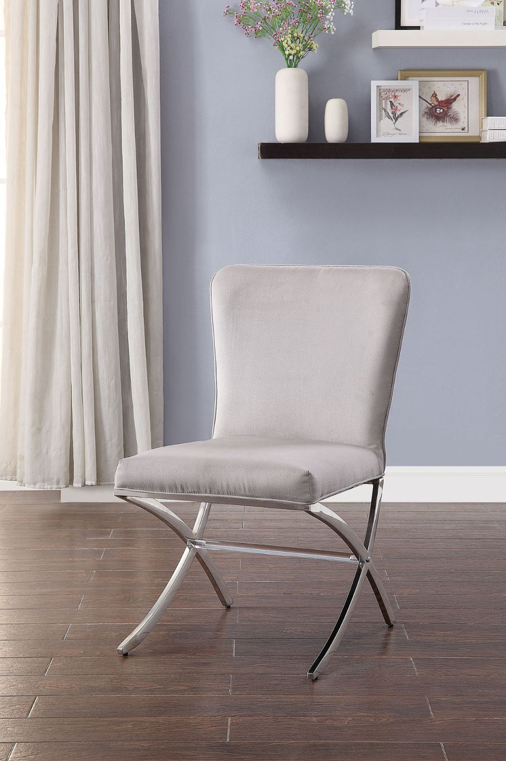 The Daire Dining Room Chair will introduce a sleek style to your kitchen or dining room. Combining both traditional and modern elements, this unique has cushioned seat and back that is wrapped in a neutral PU upholstery on a sturdy metal base. This stunni