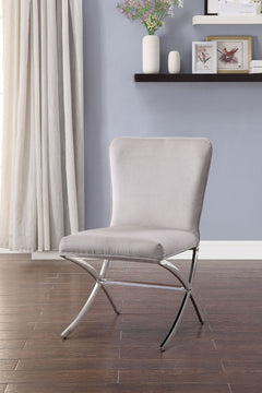The Daire Dining Room Chair will introduce a sleek style to your kitchen or dining room. Combining both traditional and modern elements, this unique has cushioned seat and back that is wrapped in a neutral PU upholstery on a sturdy metal base. This stunni