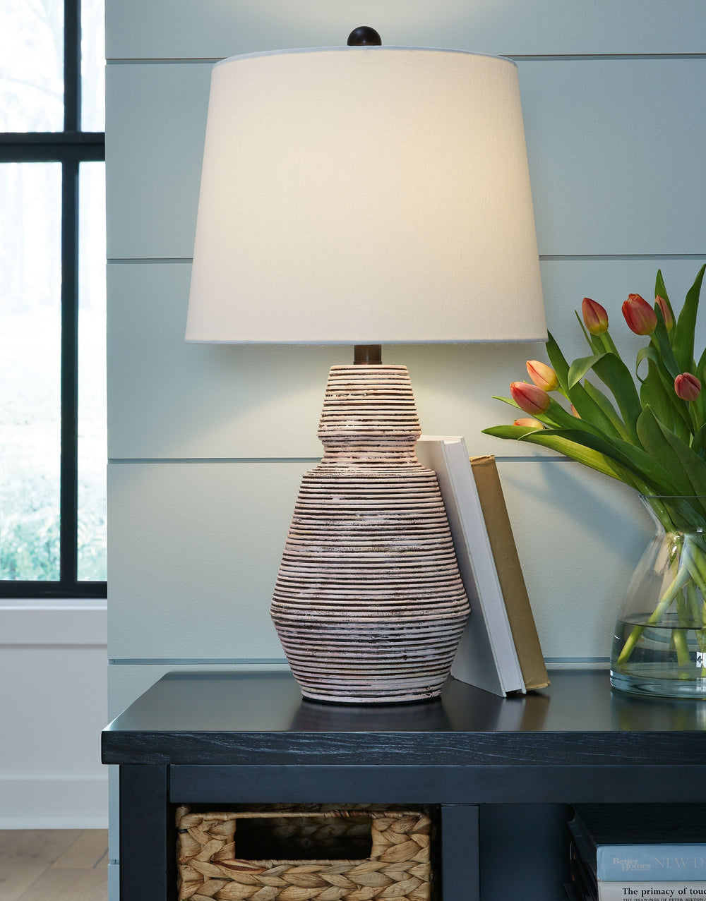 Add an impressive design element to your home with this table lamp. The distressed resin body in brick red and white is topped off with a crisp, fresh fabric shade. Low profile yet eye-catching, this lamp makes a gorgeous accent for contemporary and mid-c