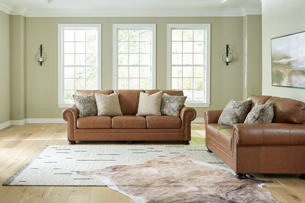 Merging traditional motifs with a modern hue, this living room set ties your transitional seating area together. Classic roll arms decorated with nailhead trim bookend the comfortable cushions for a bit of extra flair. Itâ€™s approachable, yet luxurious. 