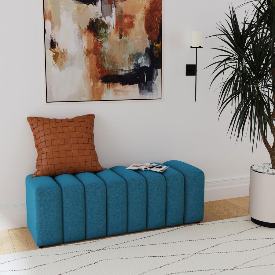 Introduce glam texture and dimension with a decorative upholstered bench. This modern creation features an undulating silhouette without arms or a back, offering sleek style and seating. Perfect for a sophisticated foyer or living room, it adds a pop of c