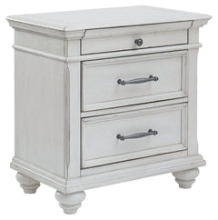 Give your retreat vintage charm and valuable bedside storage with this nightstand. In a beautifully distressed whitewash finish, two drawers and a smaller top accessory drawer will help you keep bedtime essentials nearby in casual style. Generously scaled