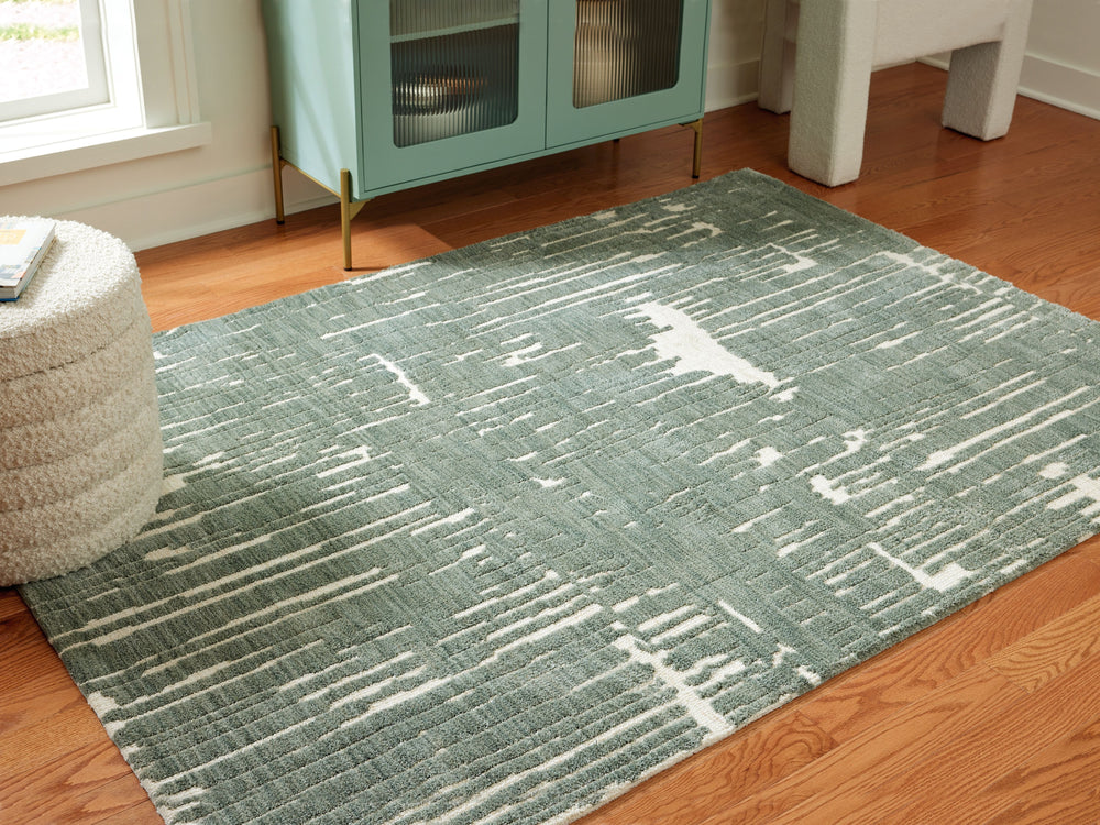Give your floors a facelift with the abstract design of this rug. It expertly executes a marriage of color and pattern to craft a contemporary feel in your home. Stage it in a room with accent pillows or wall art in matching shades of teal for a monochrom