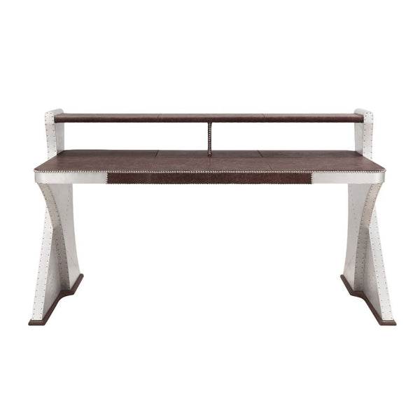 The Brancaster Aluminum Desk-'s modern look and industrial styling include retro brown top grain leather top, aluminum over plywood construction, and exposed rivets that form a patchwork over the frame. A brilliant addition to your workspace, this desk fe