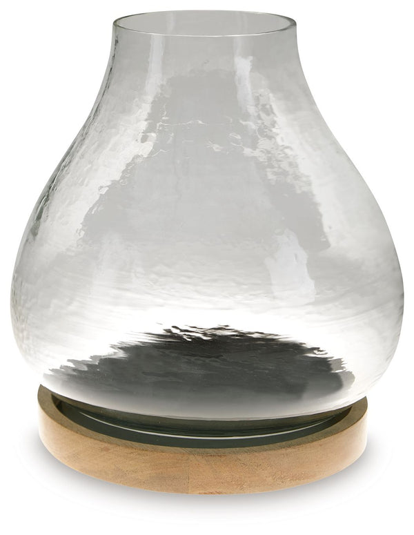 The warbled texture of this glass candle holder gives it a casual, rustic charm. Add a pillar candle in the color of your choice, or use a white candle for that classic look. The hurricane candle holder creates a lovely ambiance when placed on a dining ta
