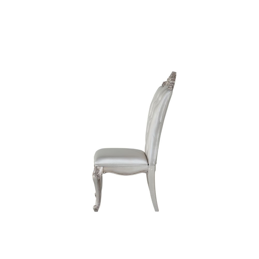 Exclusively designed and filled with romantic spirit, this beautiful chair features Queen Anne legs and carved apron and trim, decorated with raised and scrolled floral motifs in an antique champagne finish. This unique chair is upholstered in a cream fab