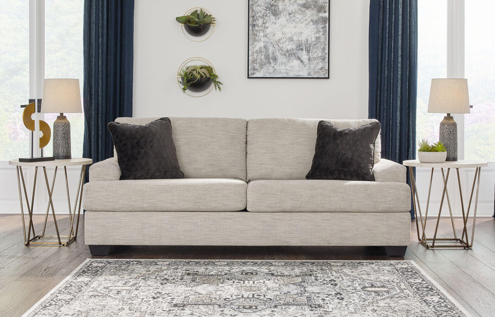 Laid-back luxury meets neutral practicality in this sofa. Taking its cues from contemporary design, the clean-lined piece is outfitted with angular arms for a layer of geometric expression. Softly upholstered, sizable cushions keep you comfortable, while 