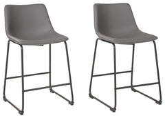 With its distinctive contoured bucket seat and tubular metal base, this bar stool serves up a fresh twist on mid-century inspired style. Chic gray faux leather upholstery adds to the aesthetic. What a timeless look for eat-in kitchens and casually cool di