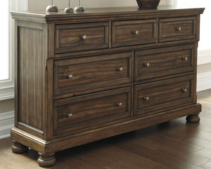 ball bearing side glides and round metal knobs in an aged brass color finish. Dresser features a hidd
