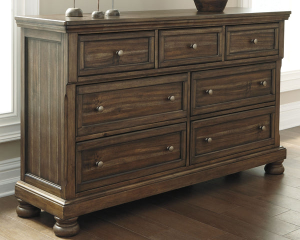  ball bearing side glides and round metal knobs in an aged brass color finish. Dresser features a hidd