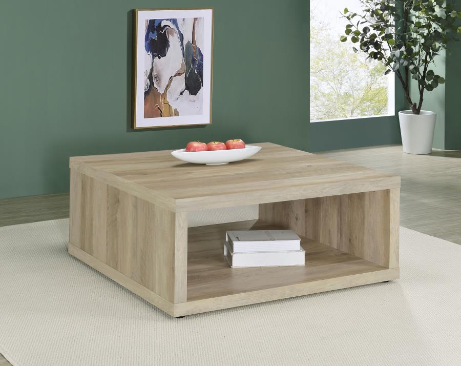 This coffee table combines rustic charm and modern simplicity, crafted from durable engineered wood with a dark pine wood-look finish. Its cube-inspired design features two open sides and a lower shelf for practical storage or display. The wood look lamin