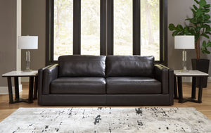  the plush cushions are wrapped with combination leather and faux leather upholstery i