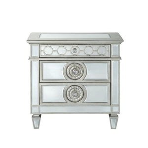 The Varian nightstand provides a commanding presence in any room. Add a dash of glam to your bedroom with this Varian nightstand, it features four tapered legs and 2 storage drawers with crystal-like knobs. This gorgeous nightstand is accented with raised