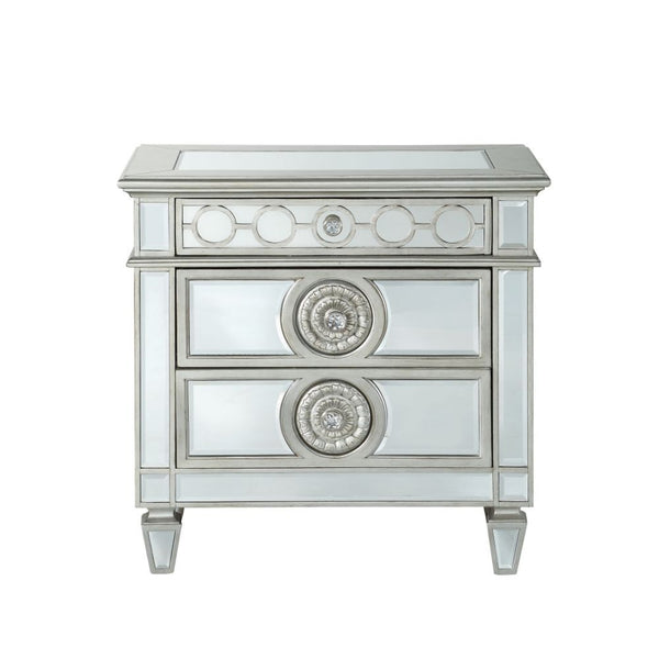The Varian nightstand provides a commanding presence in any room. Add a dash of glam to your bedroom with this Varian nightstand, it features four tapered legs and 2 storage drawers with crystal-like knobs. This gorgeous nightstand is accented with raised