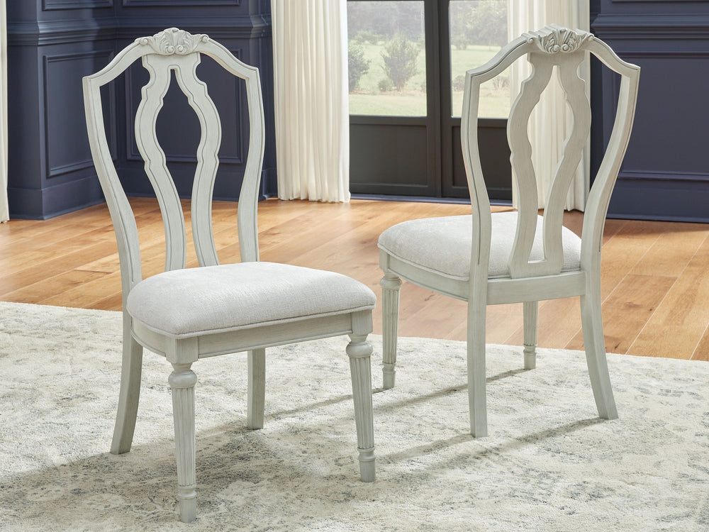 Transform your home into a haven of timeless elegance with this dining chair. Its traditional silhouette, adorned in a classic antiqued white finish, is paired with plush cushioning covered in light pearl gray upholstery. Whether you-'re settling in at me