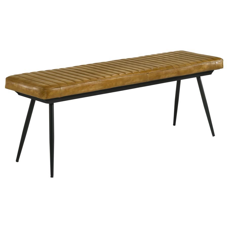 Blending rustic charm with industrial appeal, this dining bench is a bold yet versatile seating option. Upholstered in hand-dyed genuine goat leather, the padded seat with vertical tufting offers both comfort and durability. The sleek black metal base, fe