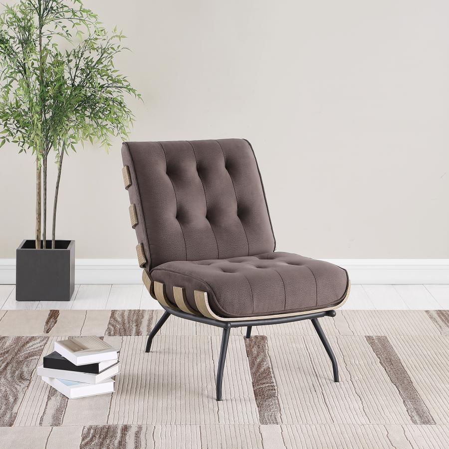 The definition of casual lies in a chic style with a coastal vibe, perfect for accenting your sun porch, living room, or family room. This accent chair features a reworked outdoor lounge chair motif with a seamed and tufted back cushion and an oversized s